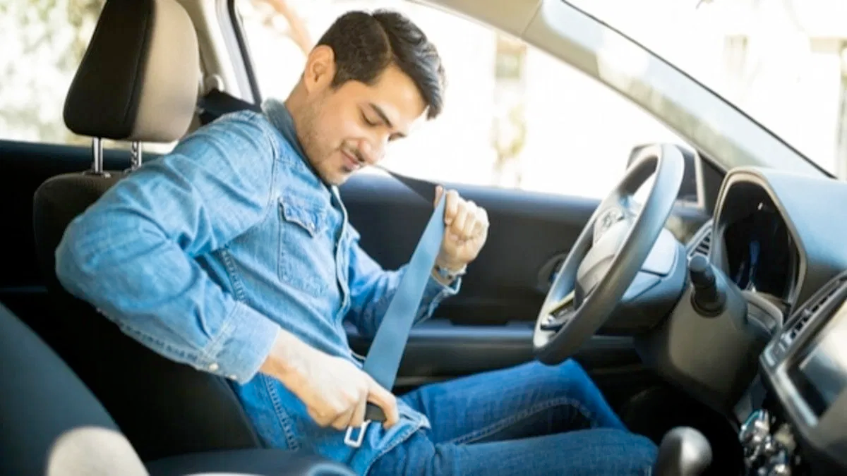 Car driving safely on the road under a clear sky, symbolizing reliable auto insurance coverage.